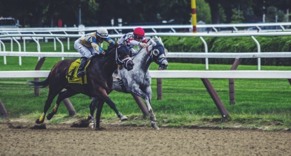 Two people horse racing