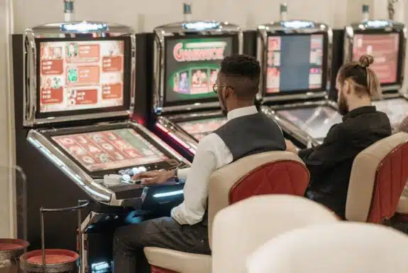 Two men playing slots