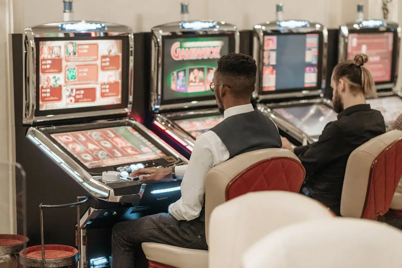 Two men playing slots